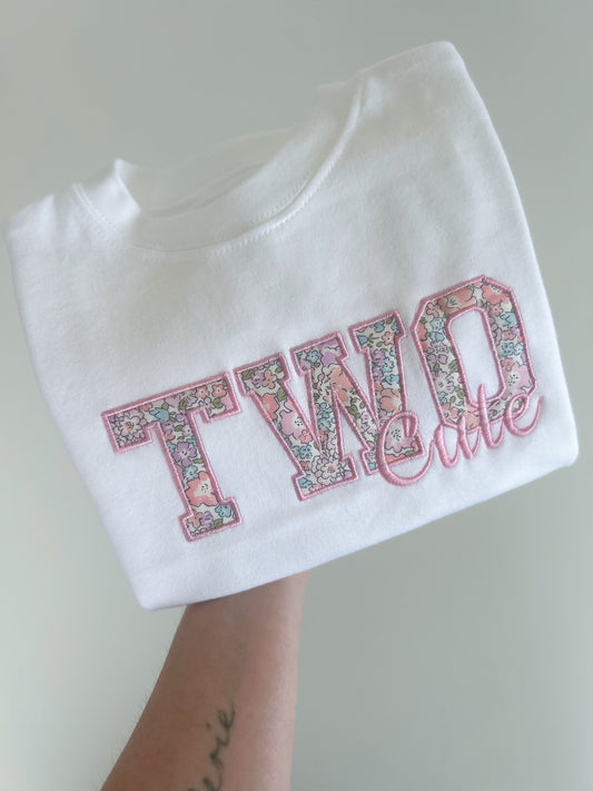 A liberty of london applique embroidered kids tshirt featuring the words TWO cute