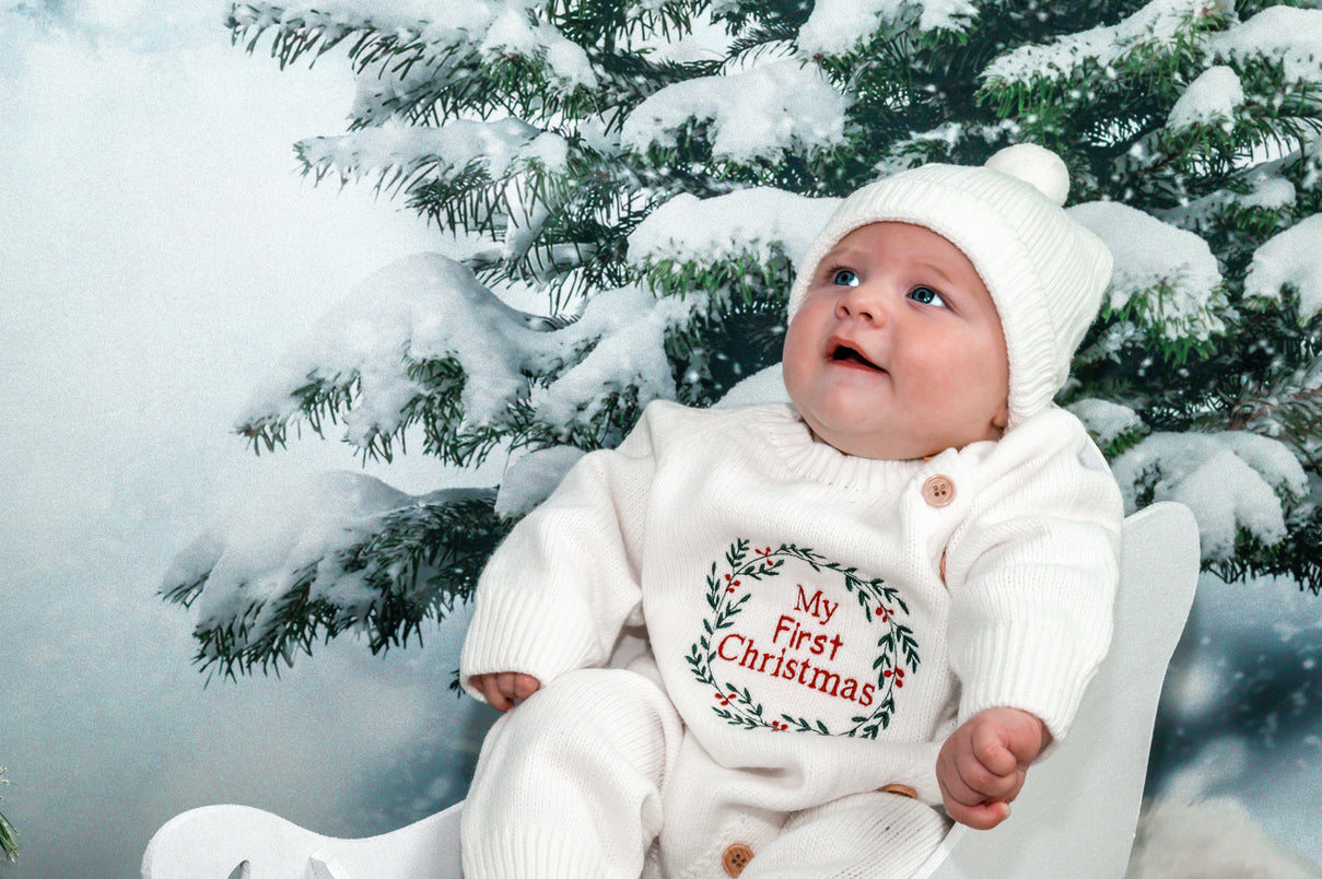 Baby Knit onesie with a wreath embroidery design with the words my first christmas