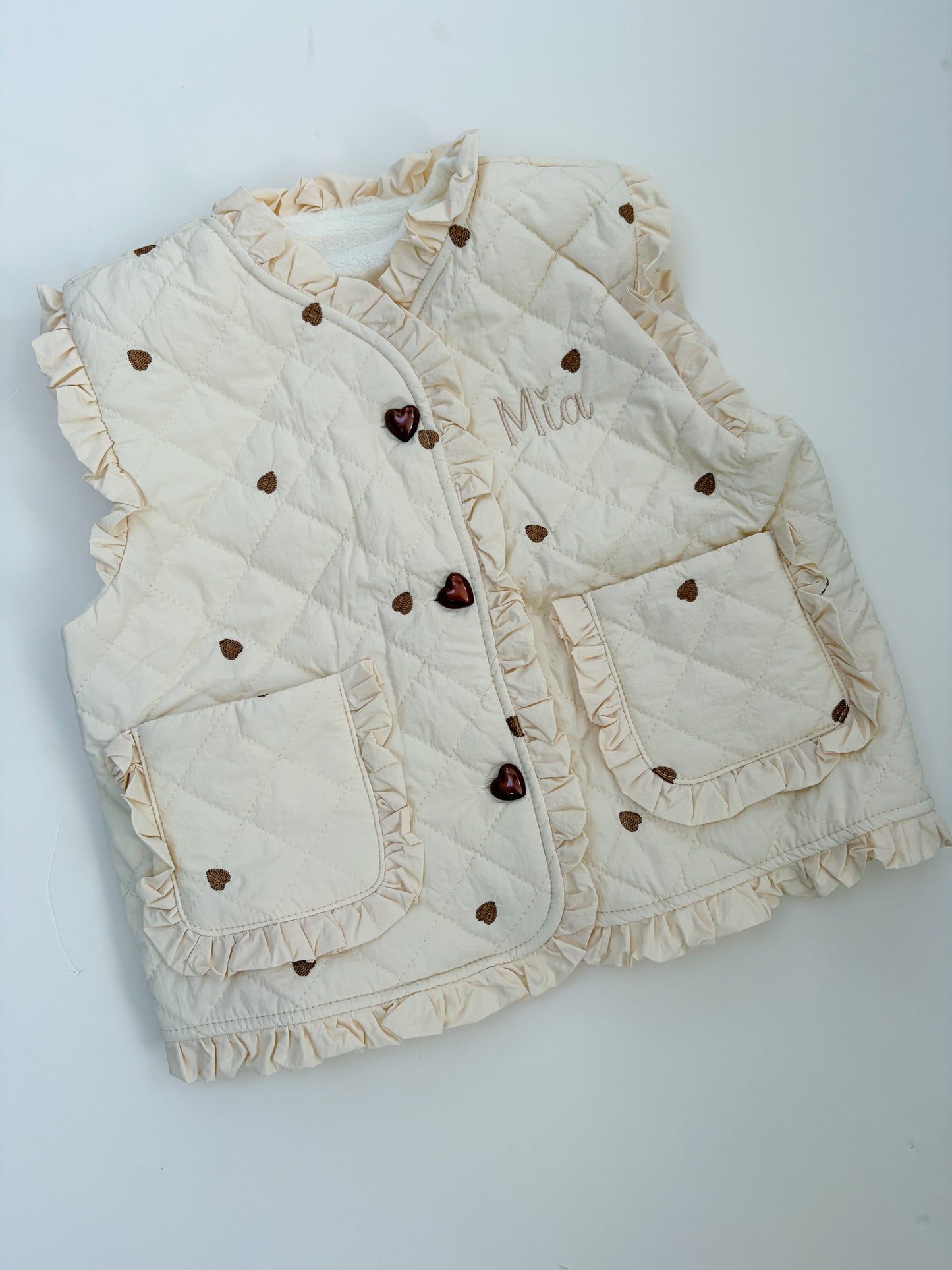 Off White gilet with heart patterns on a light gray background