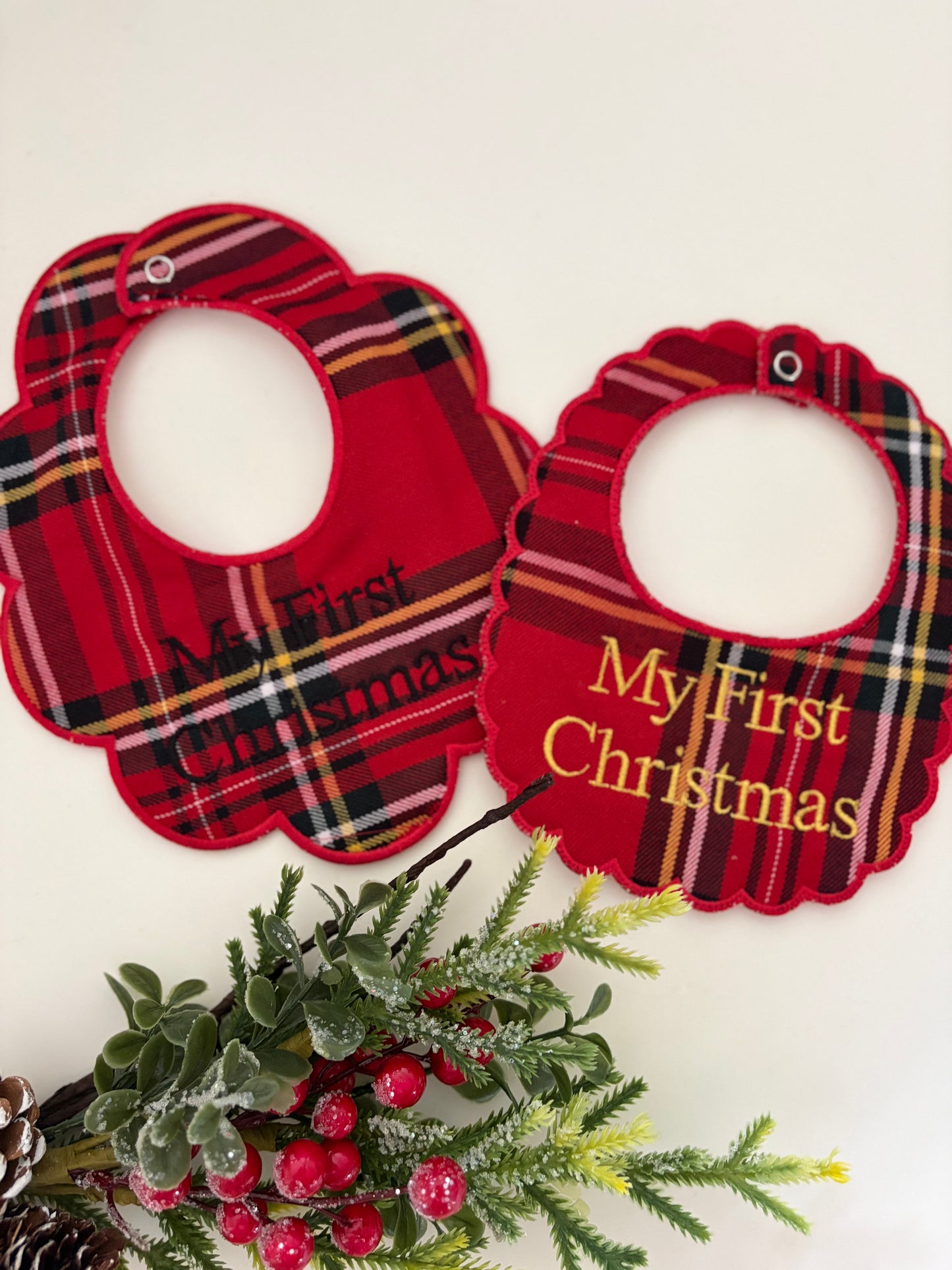 Tartan bibs personalised with my first christmas on a white background