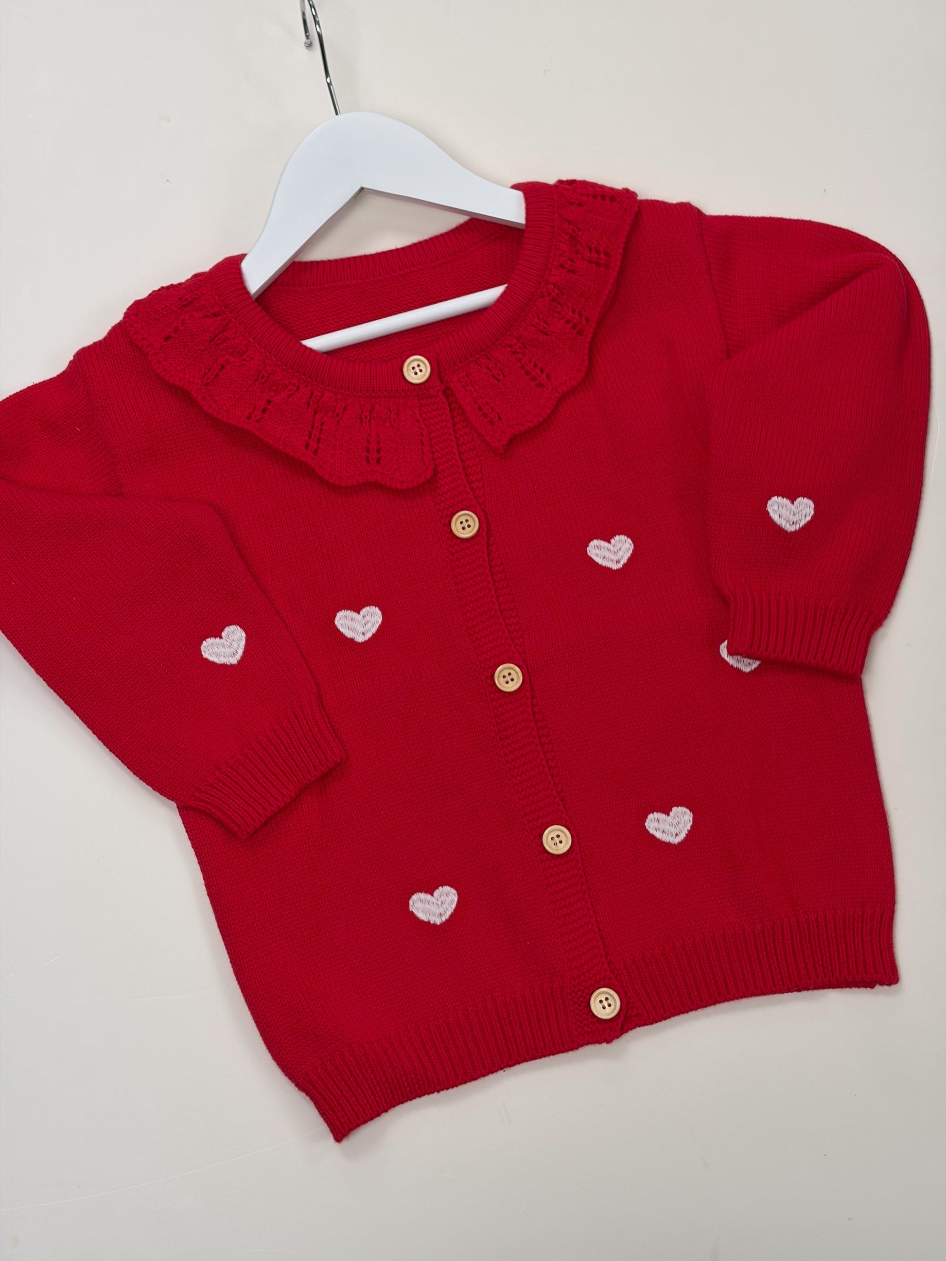 red cardigan with white embroidered love hearts 