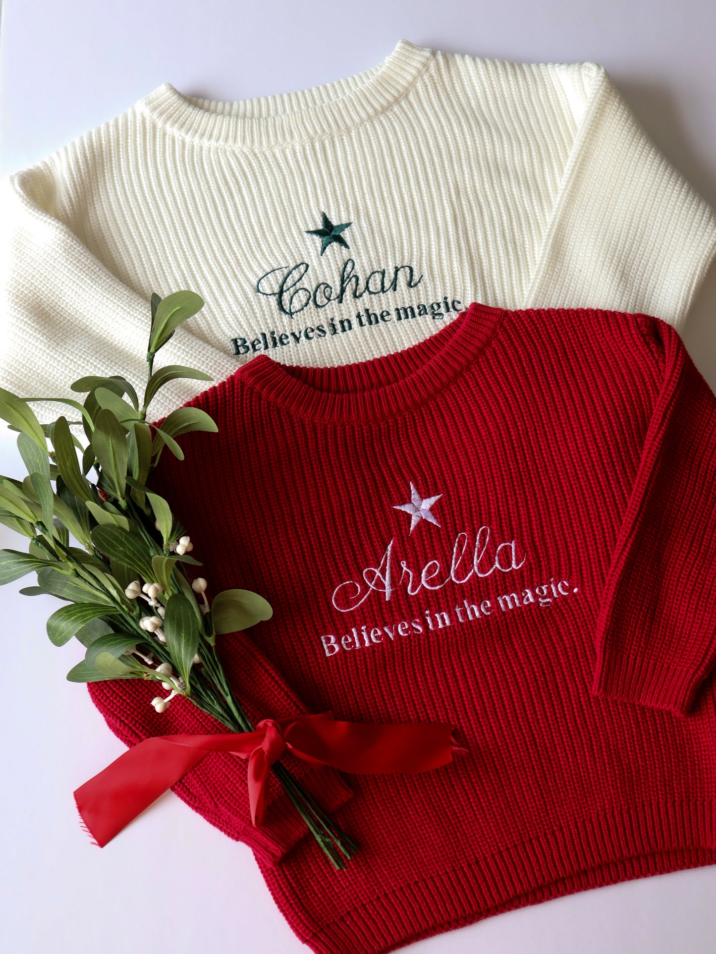 Embroidered kids knit sweater , personalised with the childs name, a star and the words believes in the magic. 