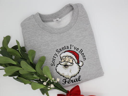 Grey Kids sweater embroidered with santa and the quote sorry santa i've been Feral