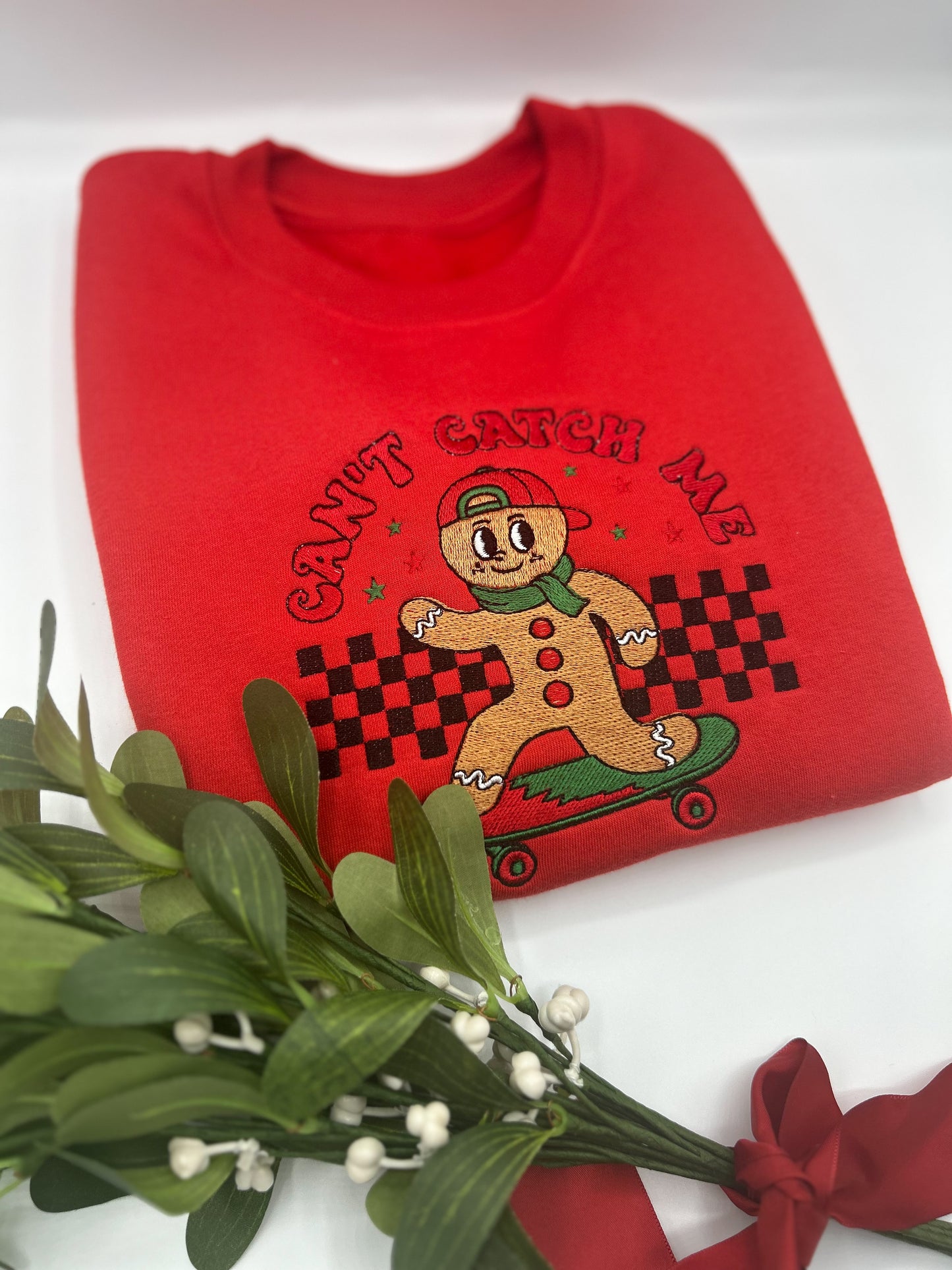 Red Kids Embroidered sweater with a gingerbread man on a skateboard featuring the words "Can't Catch Me"