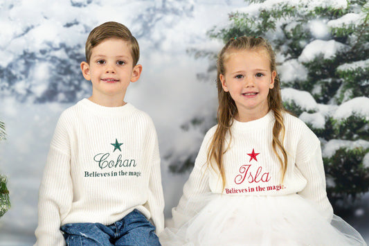 Embroidered kids knit sweater , personalised with the childs name, a star and the words believes in the magic. 