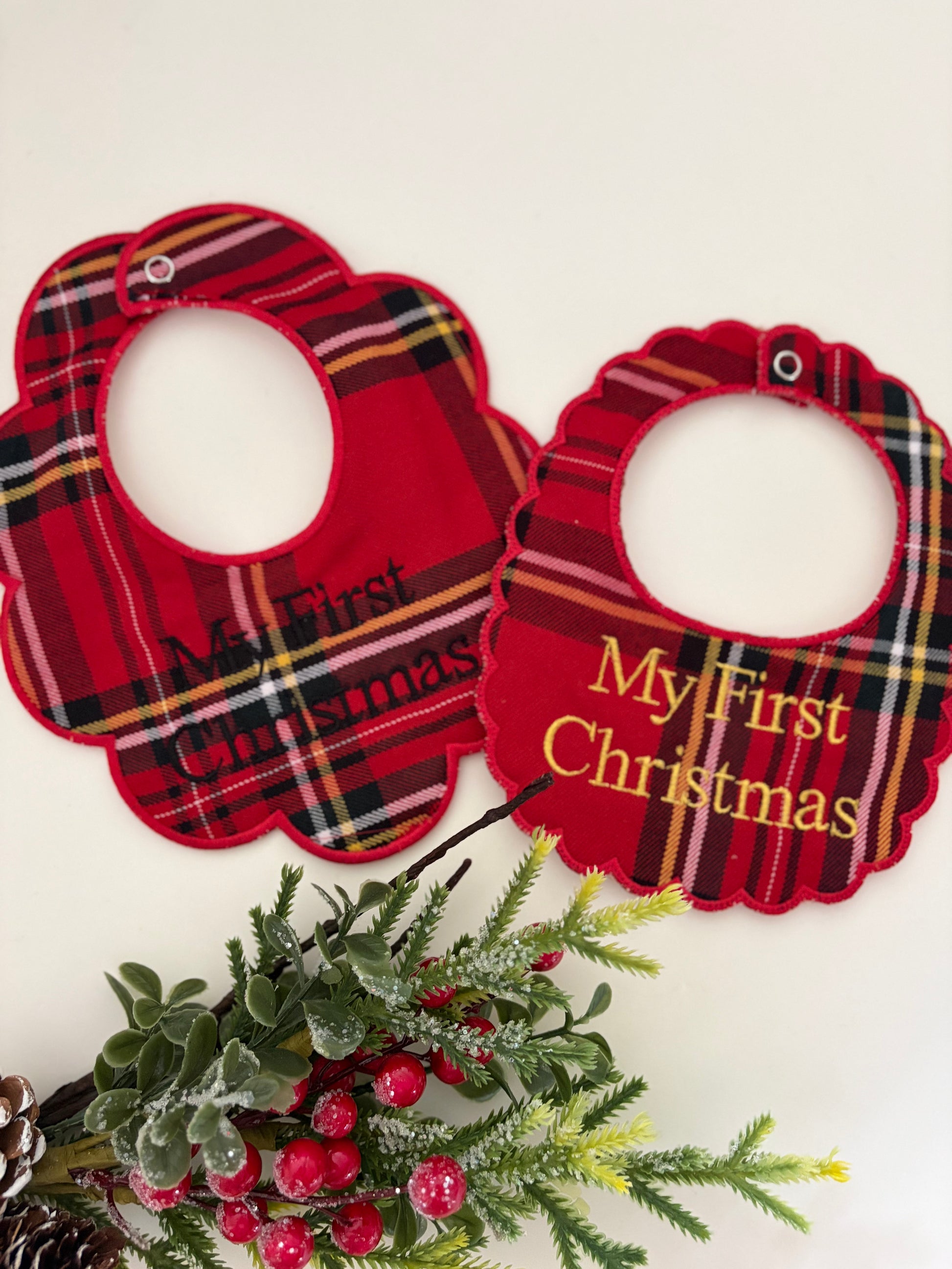 Tartan bibs personalised with my first christmas on a white background